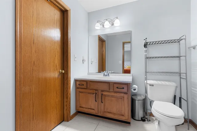 a bathroom with a toilet a sink and mirror