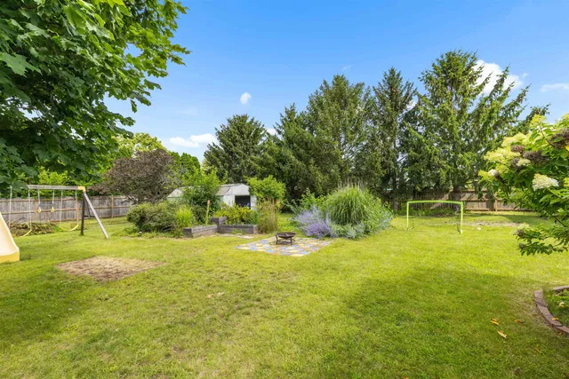 a view of a swimming pool with a garden and trees