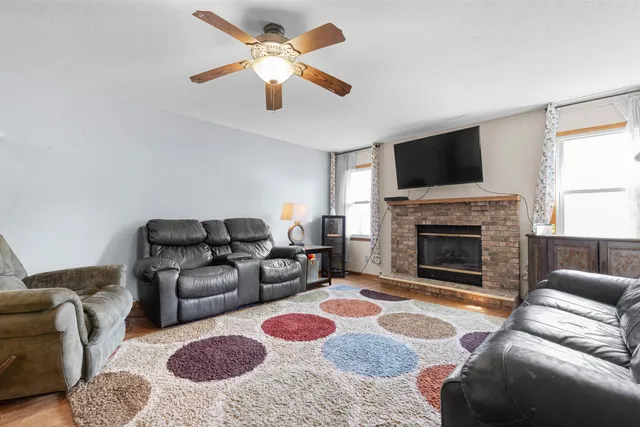 a living room with furniture fireplace and flat screen tv