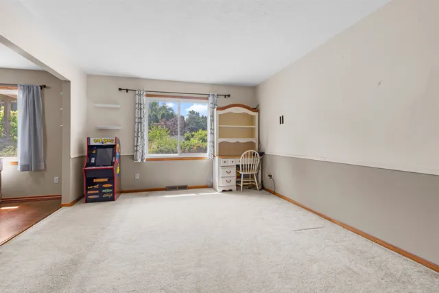 an empty room with furniture and a window