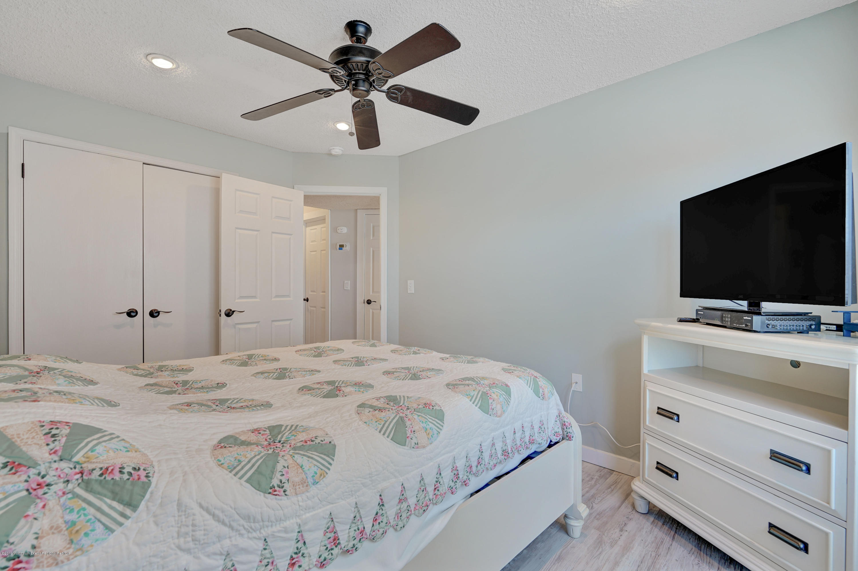 42 Hamilton Avenue, Unit B11 Seaside Heights, NJ 08751 - Photo 22 of 24 a bedroom with a bed and a flat screen tv