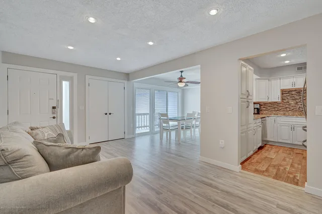 a living room with furniture and kitchen view
