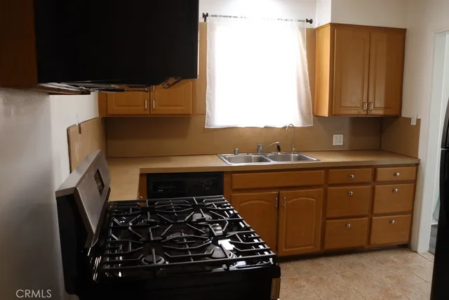a kitchen with wooden cabinets and a stove top oven