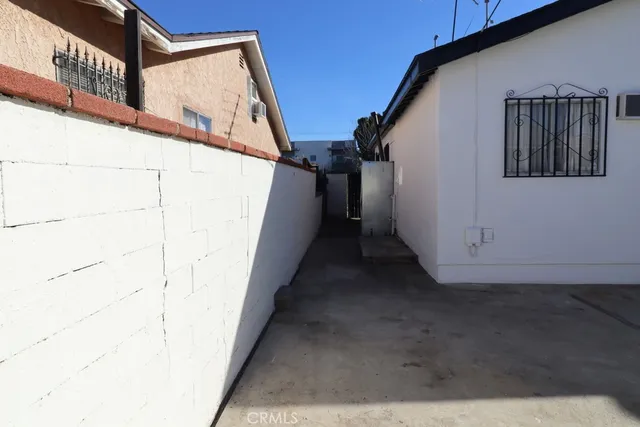 an empty room with wooden floor and closet area