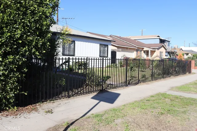 a view of a backyard with a fence