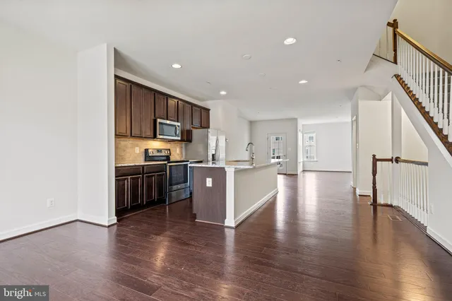 a view of kitchen with sink and wooden floor