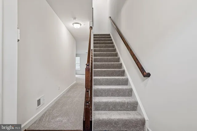 a view of staircase with white walls