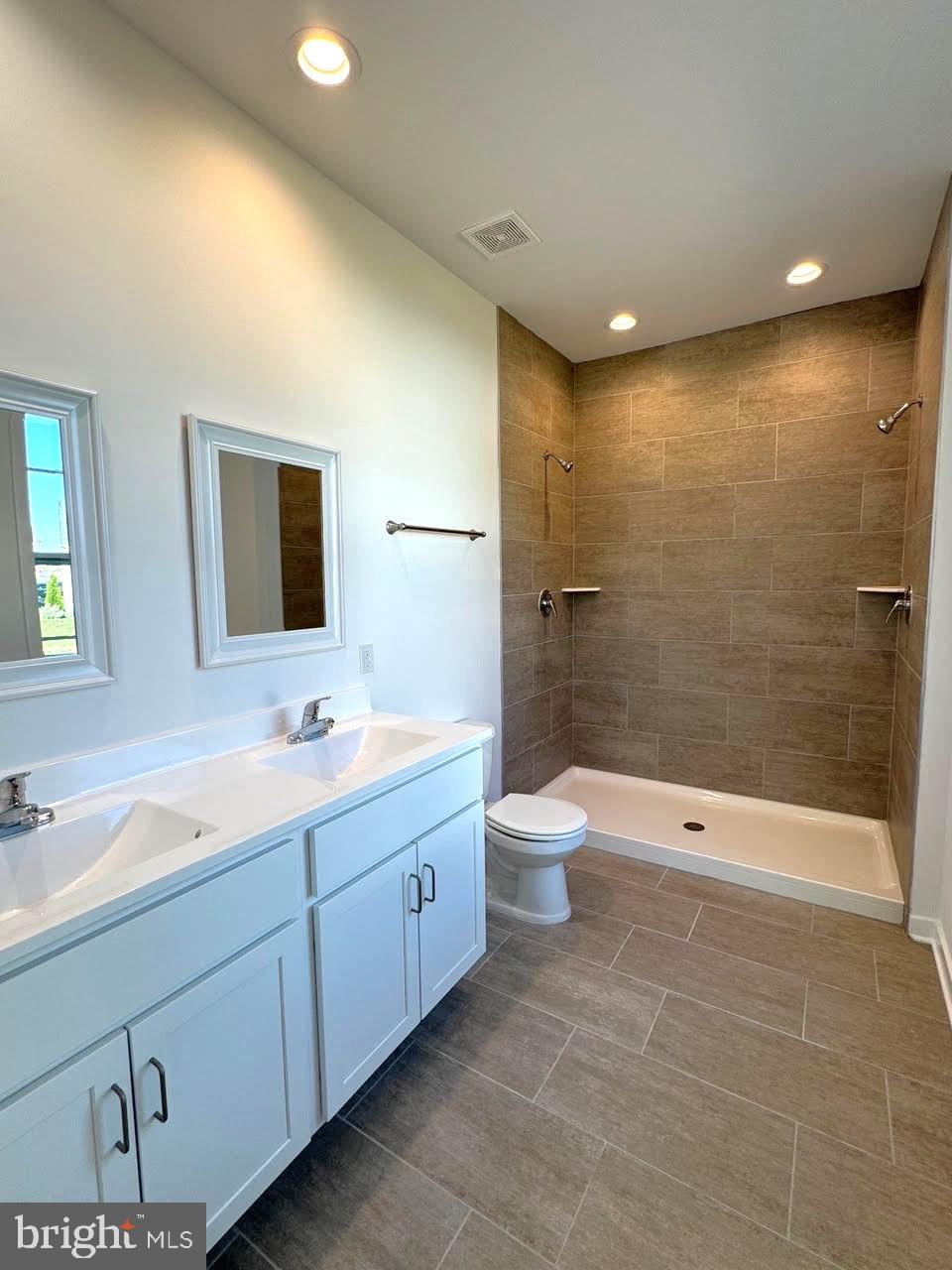 13 Glenaire Road Bunker Hill, WV 25413 - Photo 17 of 23 a bathroom with a double vanity sink toilet and shower