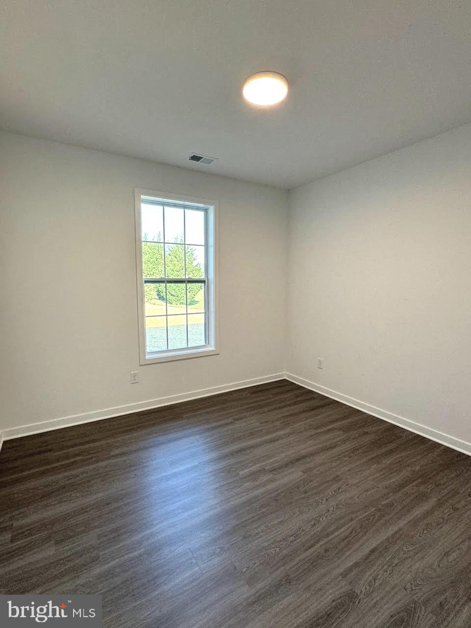 13 Glenaire Road Bunker Hill, WV 25413 - Photo 19 of 23 a view of an empty room with wooden floor and a window
