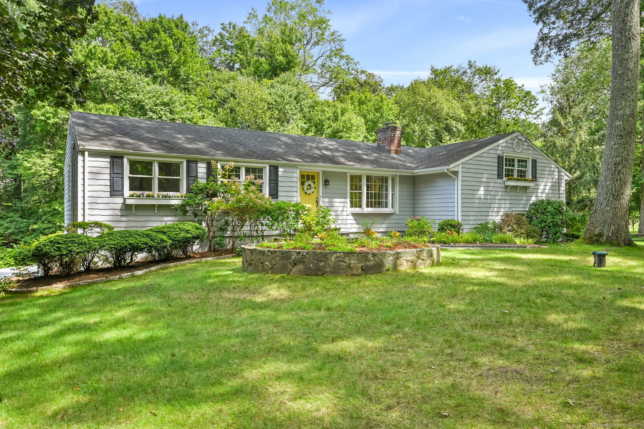 a front view of house with yard and green space