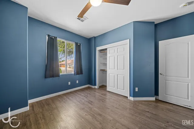 an empty room with windows and closet