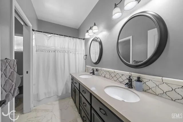 a bathroom with a double vanity sink and a mirror