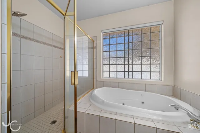 a bathroom with a bathtub and shower