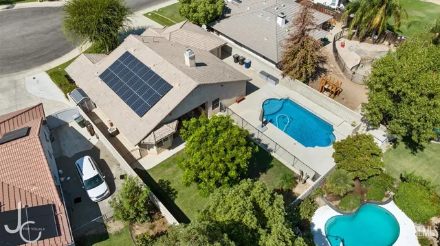 an aerial view of a house with a yard and garden