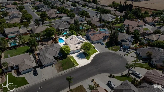 an aerial view of multiple houses with yard