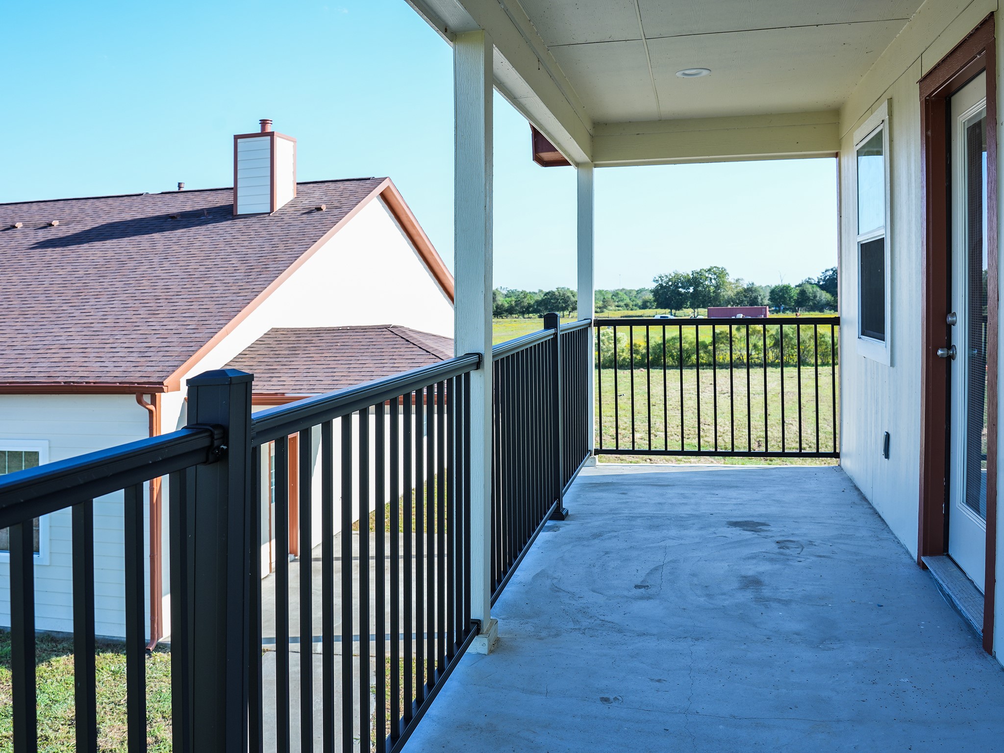 9435A Oberrender Road Needville, TX 77461 - Photo 30 of 36 a view of a balcony with floor to ceiling window and wooden floor