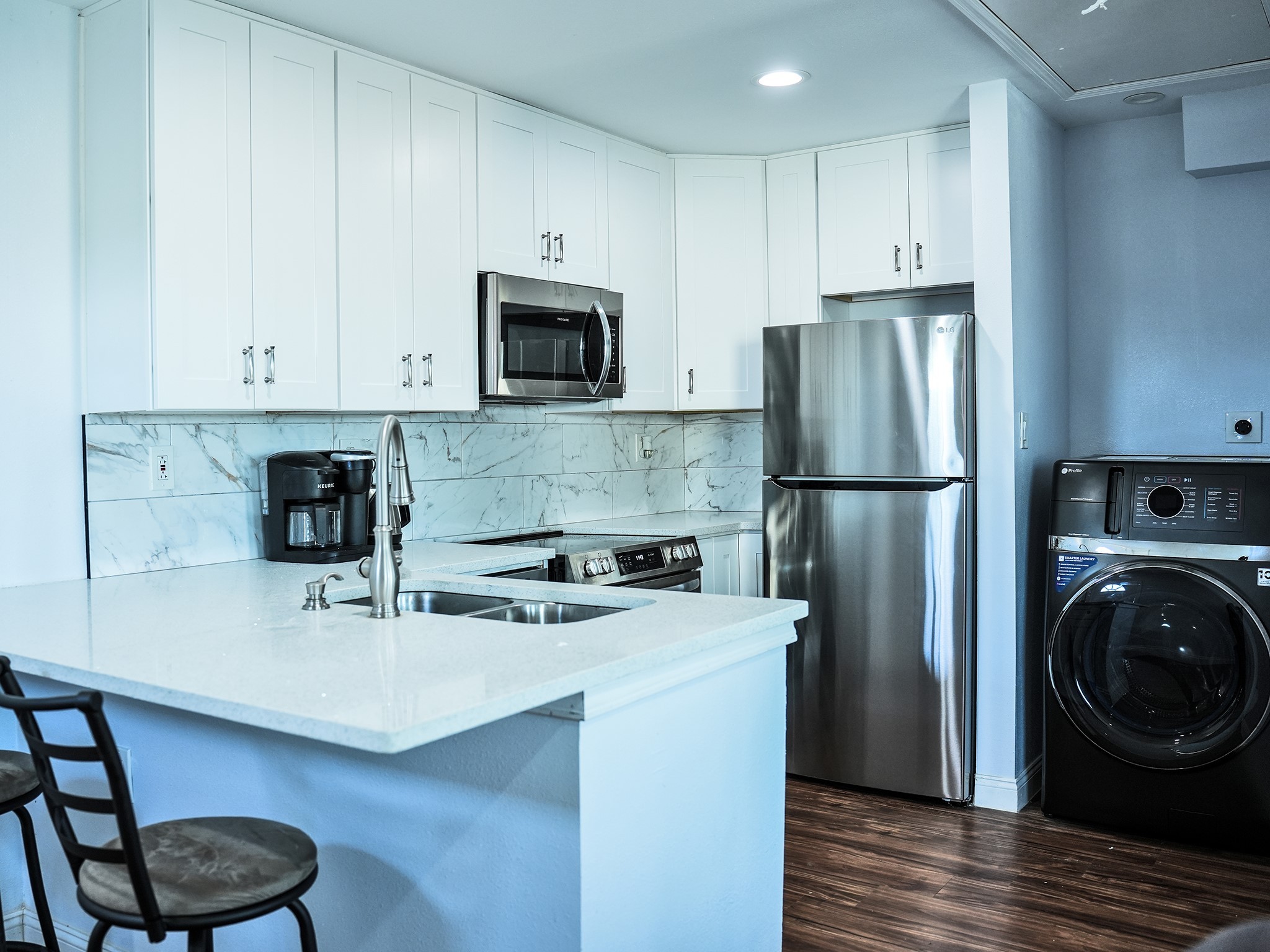 9435A Oberrender Road Needville, TX 77461 - Photo 32 of 36 a kitchen with a refrigerator a stove a sink and a stove with wooden floor