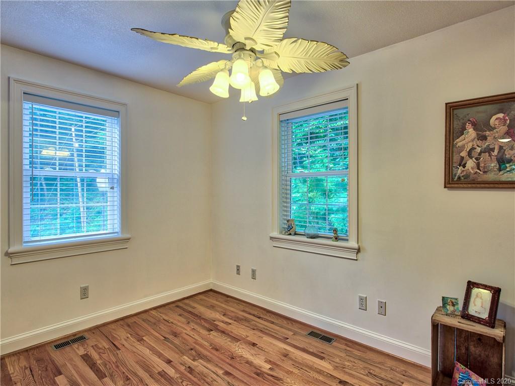 624 Bent Tree Road Maggie Valley, NC 28751 - Photo 14 of 48 a view of an empty room with a window and wooden floor