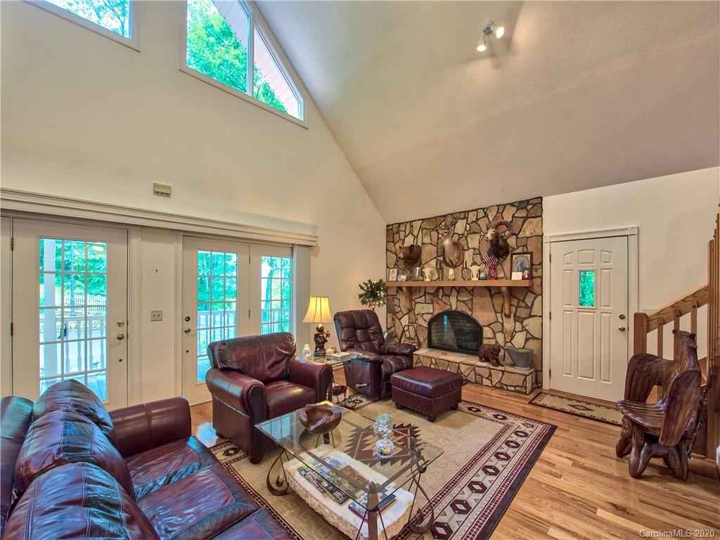624 Bent Tree Road Maggie Valley, NC 28751 - Photo 3 of 48 a living room with furniture fireplace and a large window