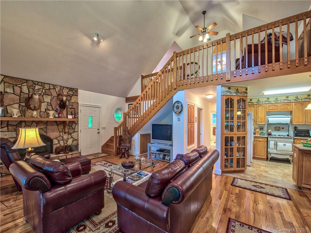 624 Bent Tree Road Maggie Valley, NC 28751 - Photo 5 of 48 a living room with furniture stairs and a view of living room
