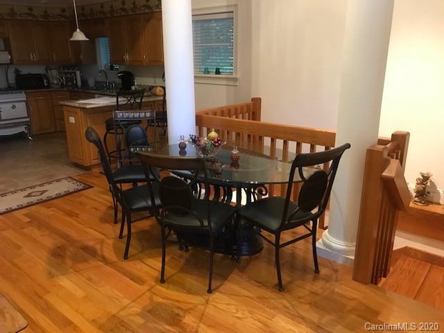 624 Bent Tree Road Maggie Valley, NC 28751 - Photo 10 of 48 a view of a dining room with furniture and wooden floor