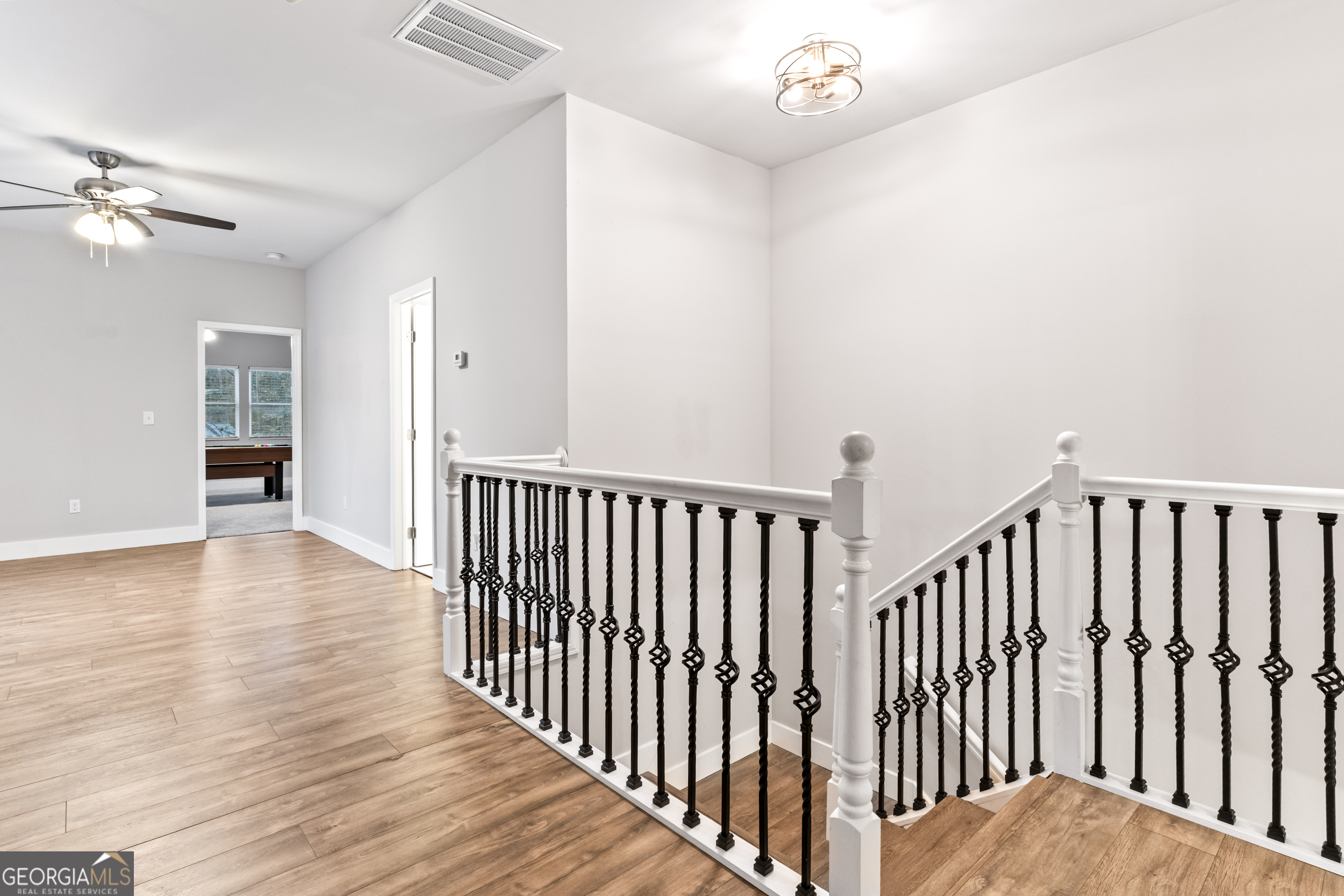 5410 Beth Drive Austell, GA 30106 - Photo 26 of 36 a view of a hallway with wooden floor and chandelier