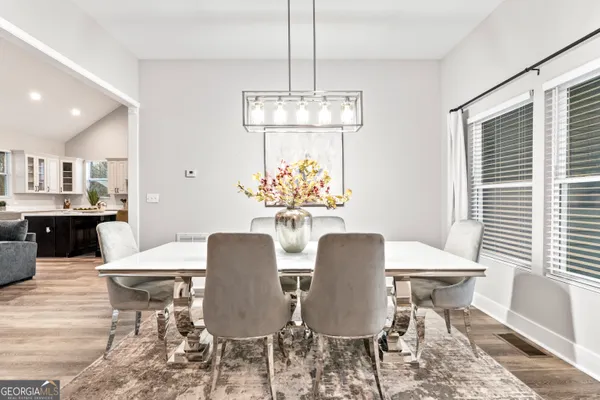 a view of a dining room with furniture window and wooden floor
