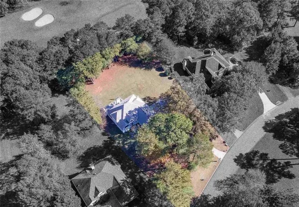 an aerial view of a house with a yard