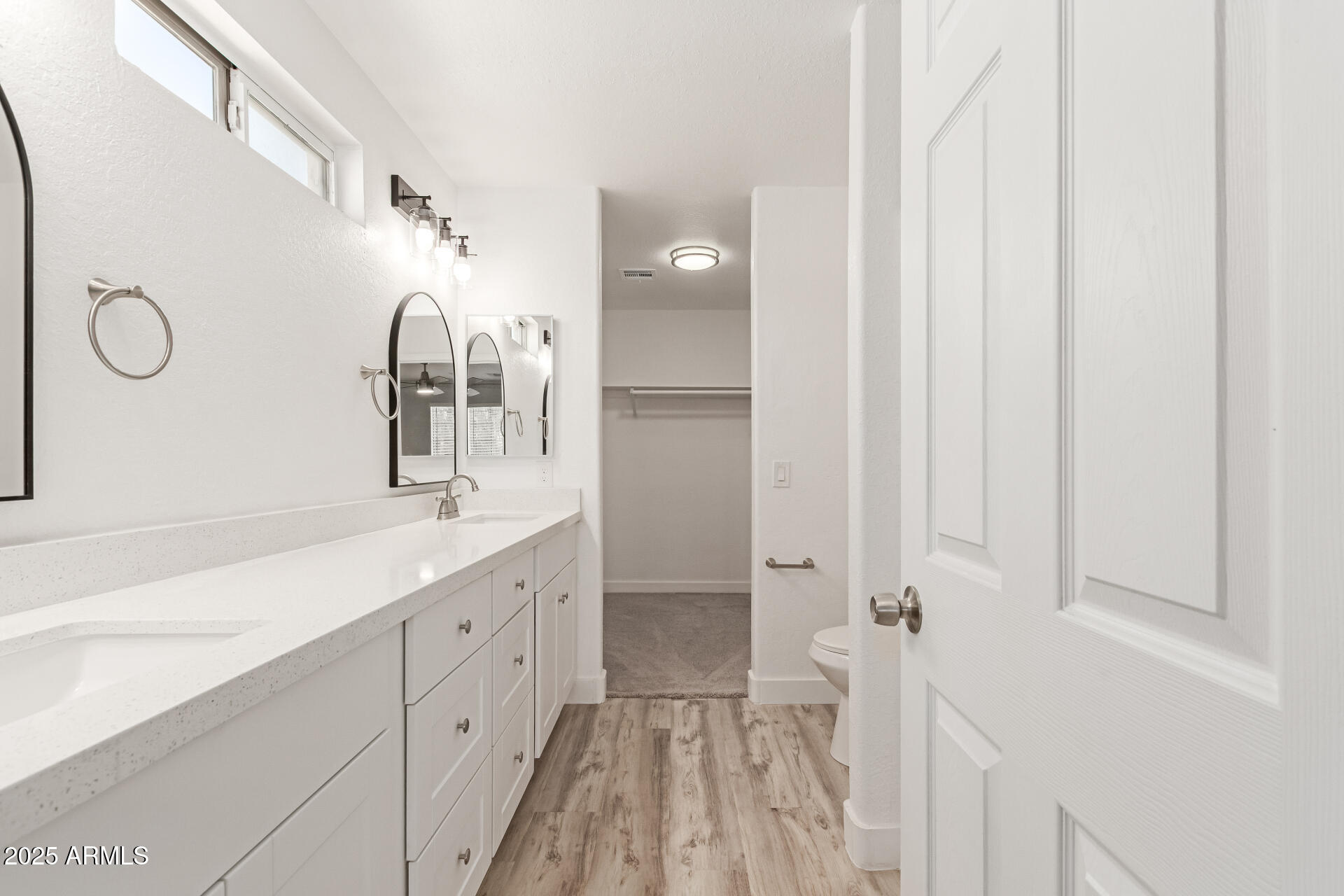 8315 West Crown King Road Tolleson, AZ 85353 - Photo 14 of 31 a spacious bathroom with a double vanity sink and mirror