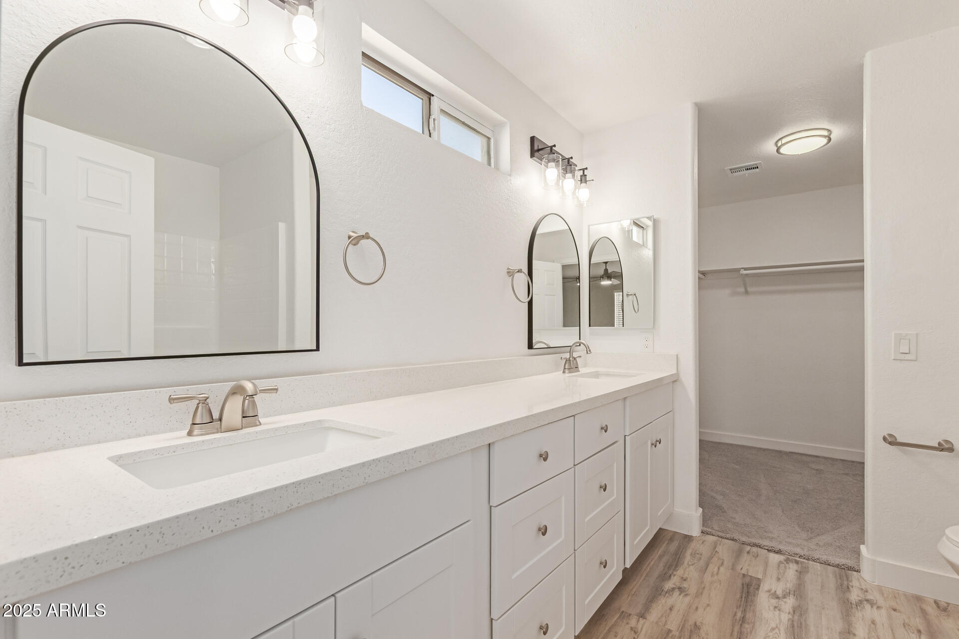 8315 West Crown King Road Tolleson, AZ 85353 - Photo 15 of 31 a bathroom with a double vanity sink and mirror