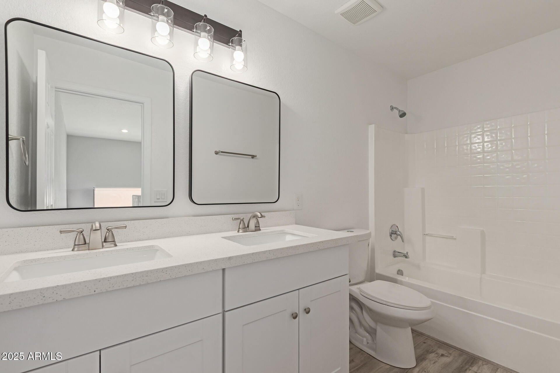 8315 West Crown King Road Tolleson, AZ 85353 - Photo 18 of 31 a bathroom with a toilet a sink a mirror a and vanity