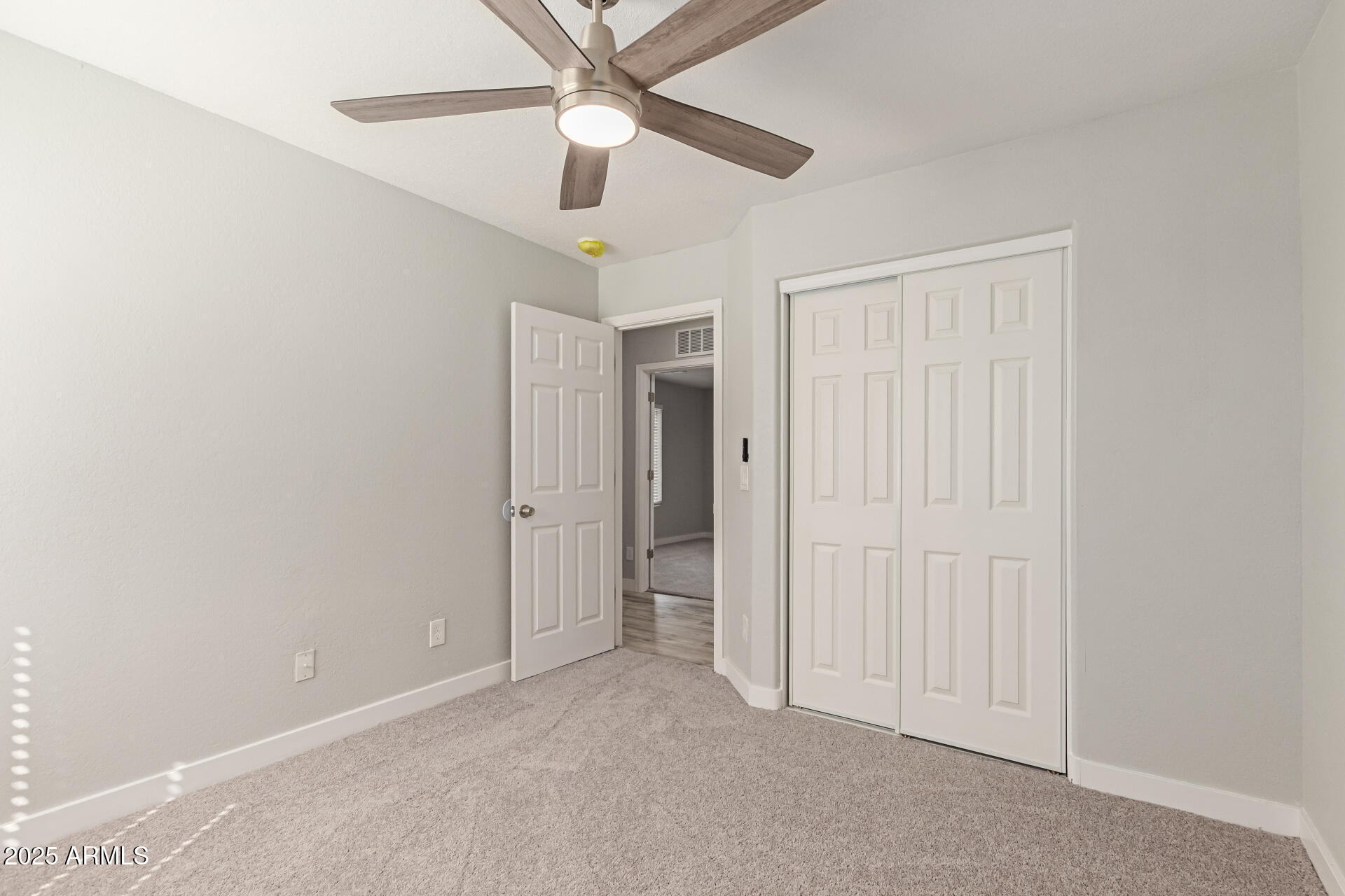 8315 West Crown King Road Tolleson, AZ 85353 - Photo 19 of 31 an empty room with a ceiling fan and a window