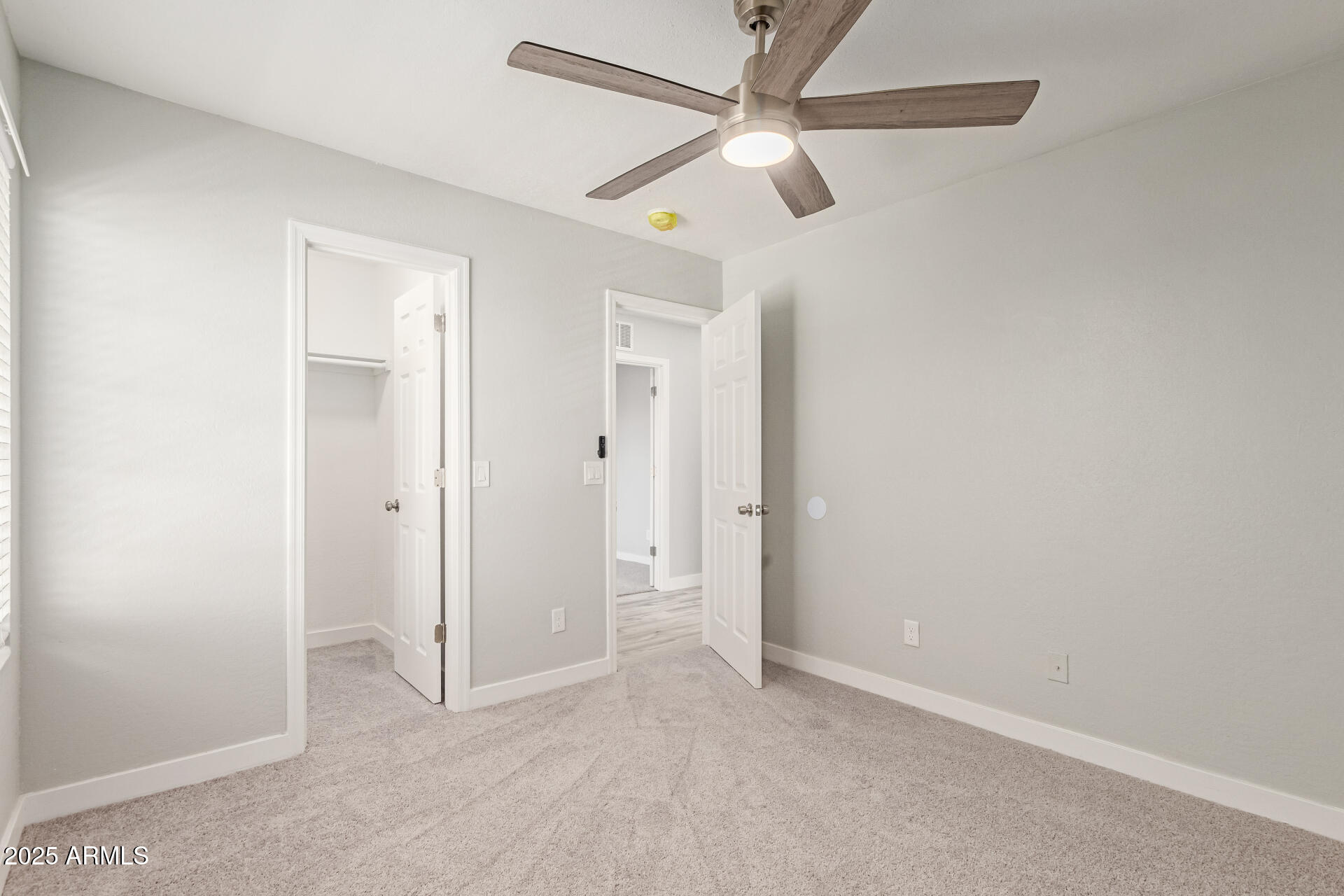 8315 West Crown King Road Tolleson, AZ 85353 - Photo 20 of 31 an empty room with ceiling fan and a ceiling fan
