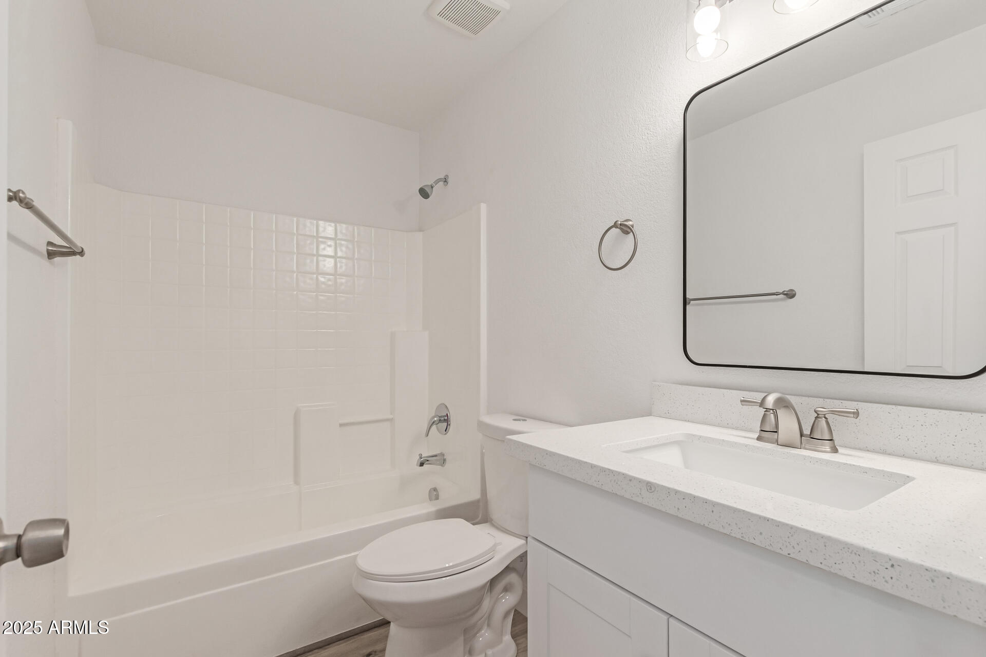 8315 West Crown King Road Tolleson, AZ 85353 - Photo 22 of 31 a bathroom with a sink toilet vanity and shower
