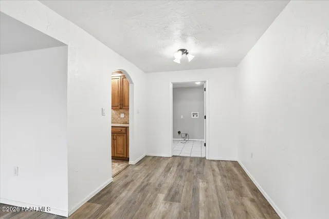 an empty room with closet and wooden floor