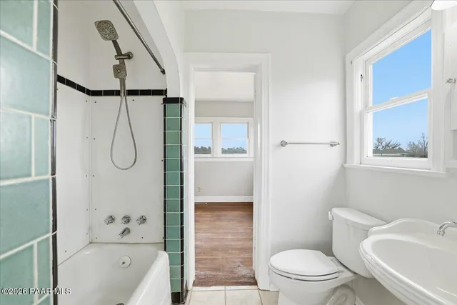a bathroom with a toilet sink and shower