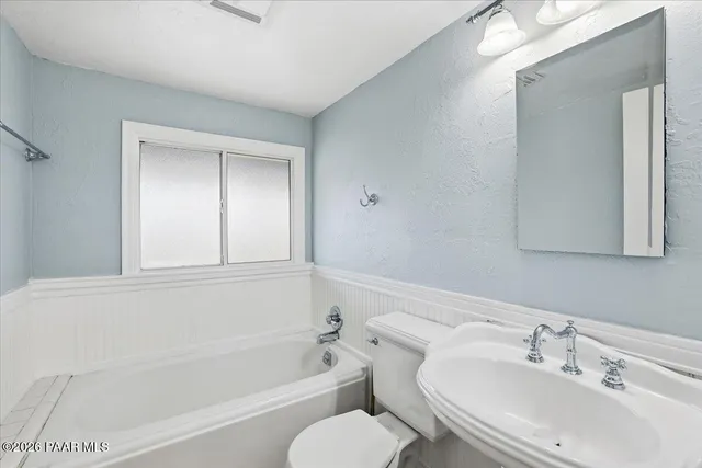 a bathroom with a sink toilet and bathtub