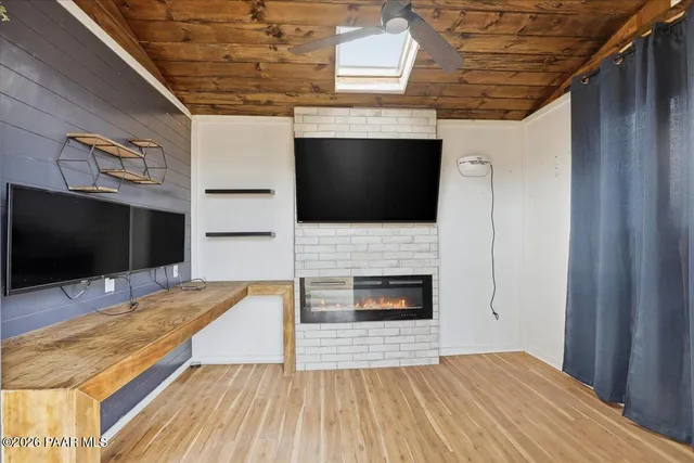 a living room with a flat screen tv and a fireplace