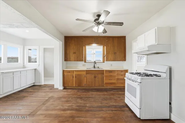 a kitchen with a stove a sink and a refrigerator