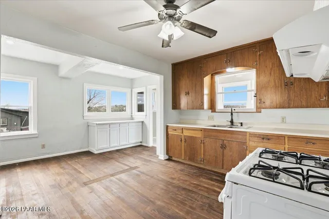 a kitchen with stainless steel appliances a stove a sink and a refrigerator