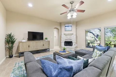 a living room with furniture and a view of kitchen