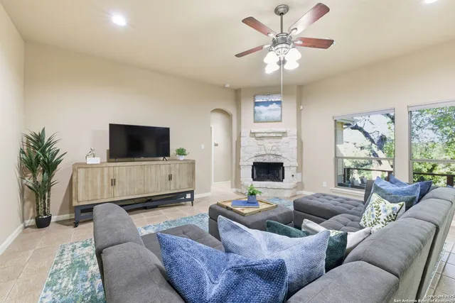 a living room with furniture and a view of kitchen