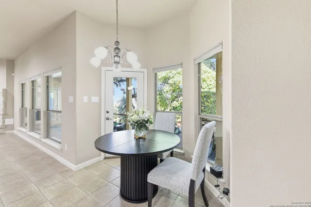 a kitchen with stainless steel appliances granite countertop a sink a refrigerator and a white cabinets