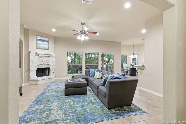 a living room with furniture a fireplace and a flat screen tv