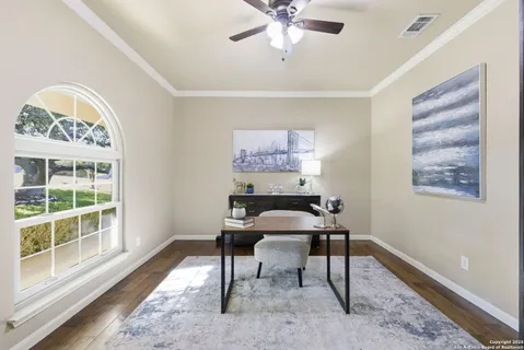 a living room with furniture a large window and a fireplace