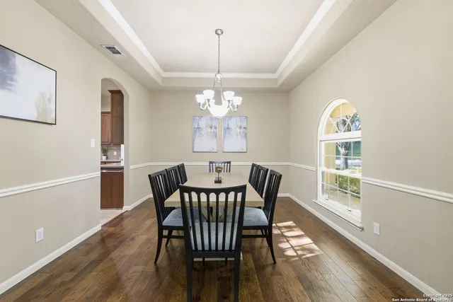 a view of a dining room with furniture window and wooden floor