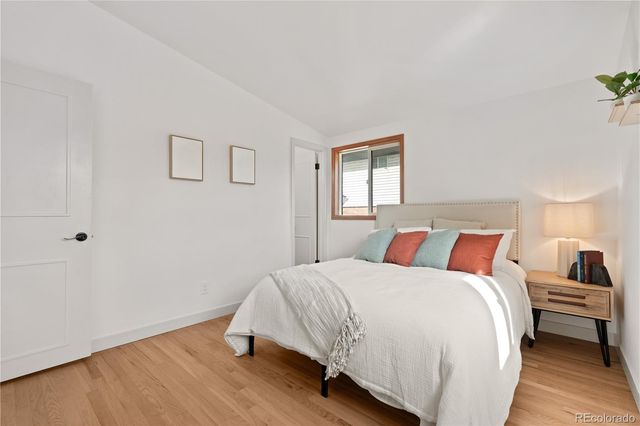 an aerial view of a house with a yard and a large tree