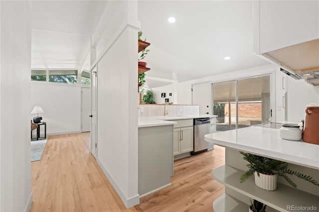 an empty room with a cabinet and a refrigerator