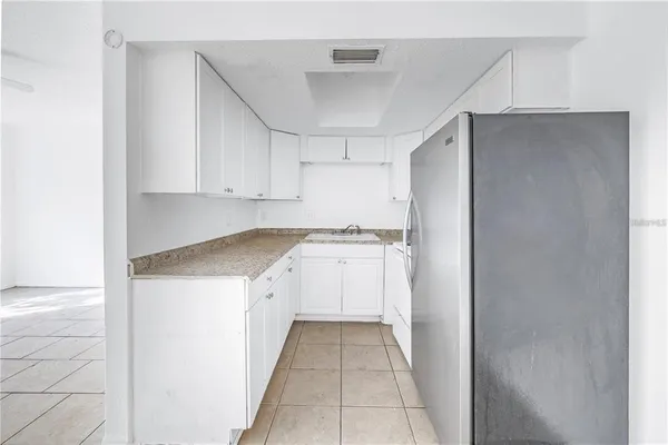 a utility room with cabinets washer and dryer