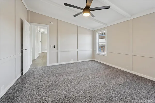 a view of a livingroom with a ceiling fan and window